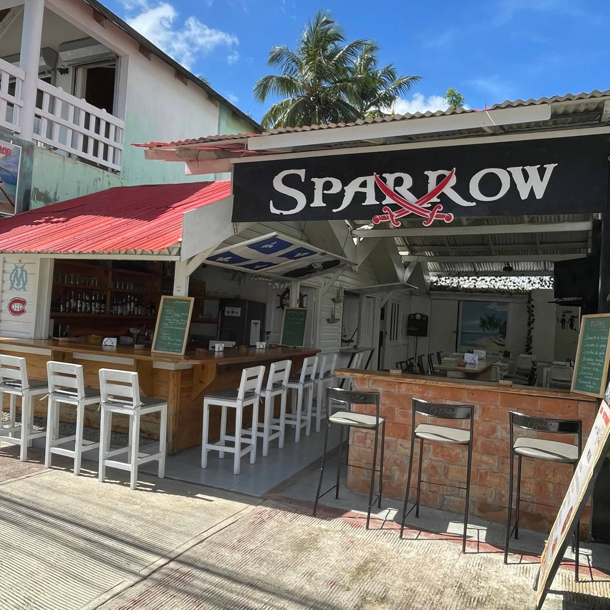 Sparrow's wooden bar and white stools