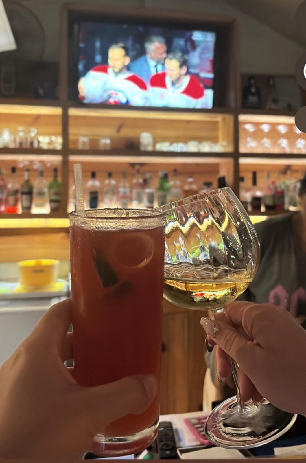 Cheers with a Caesar and a glass of white wine in front of the match