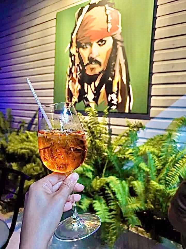 Spritz in front of the pirate portrait on the courtyard wall