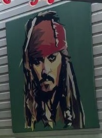 Painted portrait of a pirate captain hanging at Sparrow